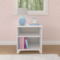 White nightstand with books, blue clock, and geometric lamp in a pink-patterned bedroom.