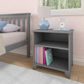 Gray kids' bedroom nightstand with books, modern lamp, and clock.