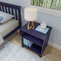 Blue nightstand with books, modern table lamp, and a white clock in a cozy bedroom setting.
