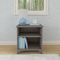 Modern gray nightstand with books, blue lamp, and clock next to a patterned blue wall.