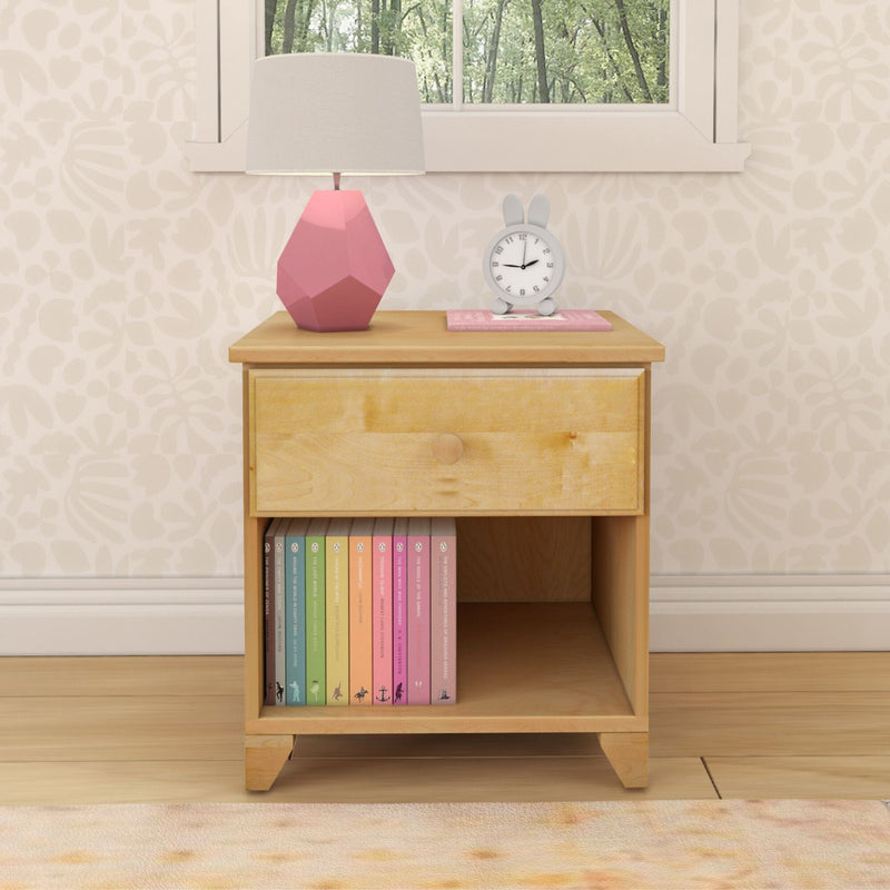 Wooden nightstand with a pink geometric lamp, bunny-shaped clock, and colorful books, in a cozy bedroom setting.