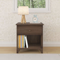Wooden nightstand with books, table lamp, and clock in modern bedroom setting.