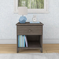 Modern wooden nightstand with books and a lamp in a cozy bedroom setting.