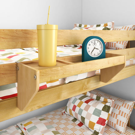 Wooden bunk bed bedside organizer shelf holding a yellow tumbler with straw and teal alarm clock above colorful checkered kids' bedding — space-saving bedside storage for children's bedroom