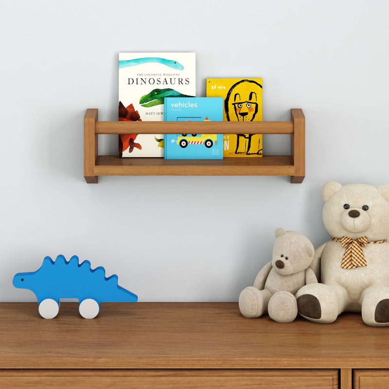 Wooden nursery shelf with children's books, stuffed teddy bears, and blue dinosaur toy on dresser.