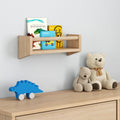 Children's wooden bookshelf with colorful books, toys, and teddy bears in a cozy nursery room.