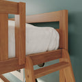 Close-up of solid wood bunk bed ladder and side rail with white bedding against a teal bedroom wall, modern wooden bunk bed detail
