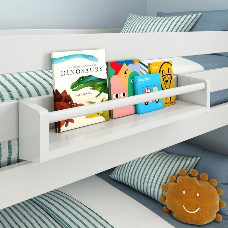 Children's bunk bed with a built-in bookshelf, featuring books and a smiling face pillow on a striped bedding background.