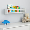 Children's bookshelf with colorful books, toy dinosaur, and teddy bears on white dresser in a modern nursery room.
