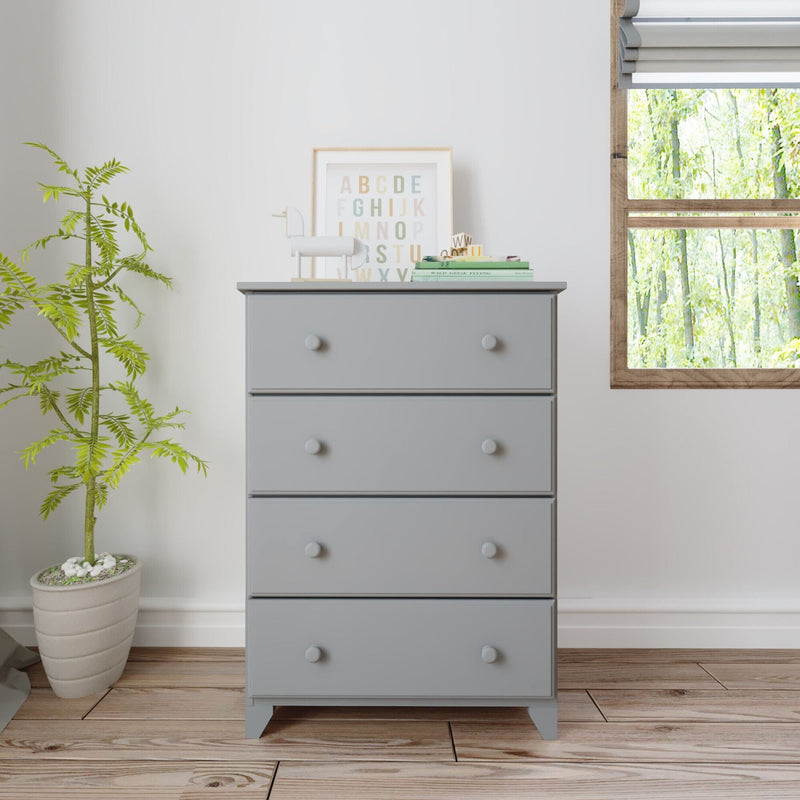 Gray wooden dresser with four drawers beside a potted plant, modern minimalist interior design.
