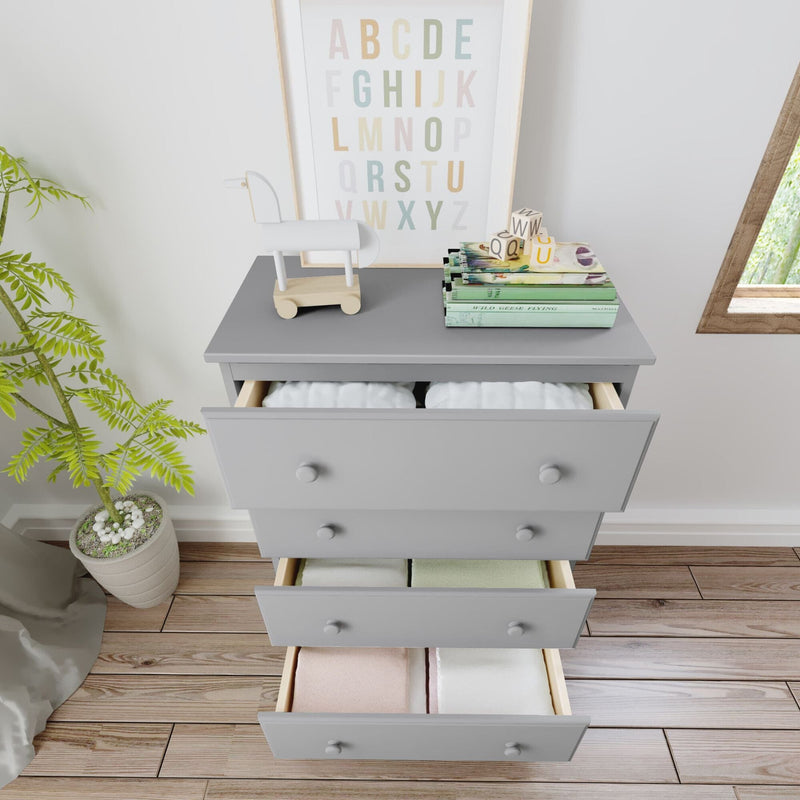 Gray baby dresser with open drawers, colorful books, toy horse, and potted plant in a modern nursery.