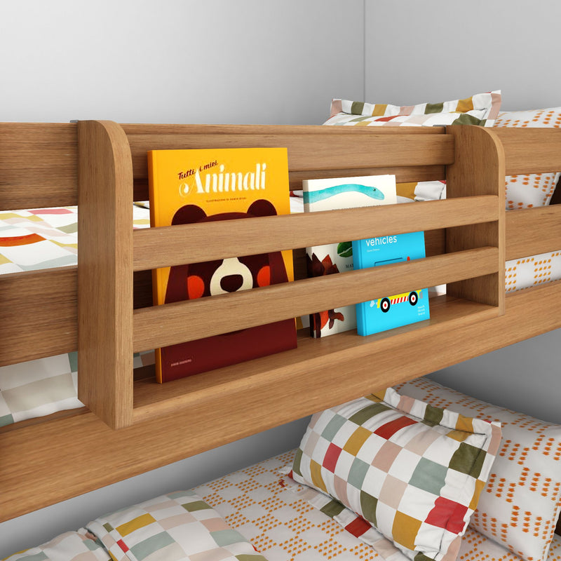Modern oak kids' bunk bed with built-in slatted bookshelf holding colorful children's board books, checkered pillows and patterned bedding