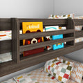 Dark wood children's bunk bed with built-in bookshelf holding colorful kids' books and patterned pillows, perfect kids' bedroom storage and reading nook