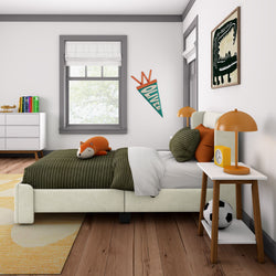 Modern children's bedroom with cozy bed, toy, and stylish decor.