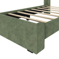 Green upholstered bed frame with wooden slats and modern design.