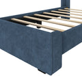 Blue upholstered bed frame with wooden slats, modern design furniture for bedroom.