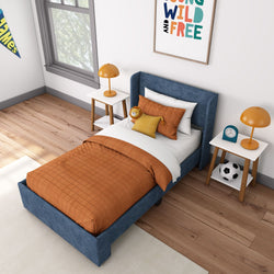 Cozy children's bedroom with blue bed frame, orange bedding, and playful decor.