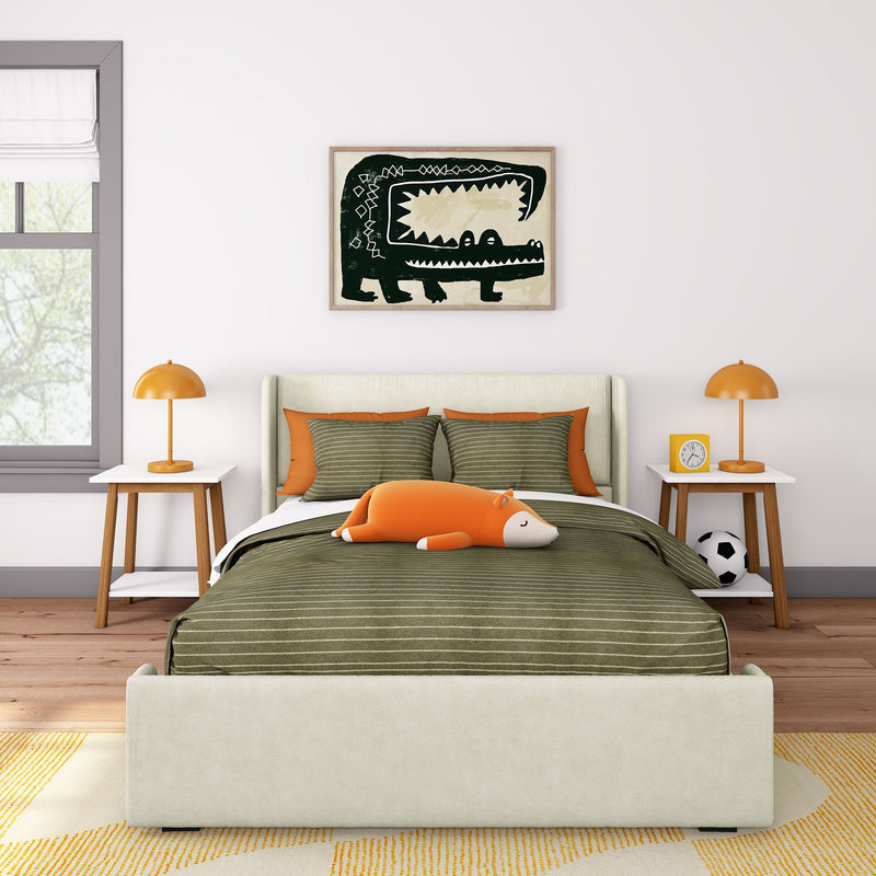 Stylish children's bedroom with green-striped bedding, orange cushions, playful fox plushie, and modern decor.