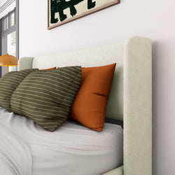 Cozy bedroom interior with modern bed, striped and orange pillows, and contemporary artwork for stylish home decor.