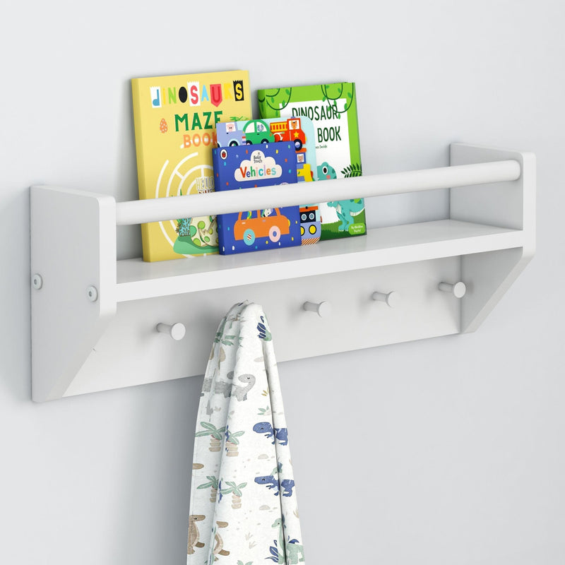White wall-mounted shelf with children's books and a hanging towel featuring dinosaur designs.
