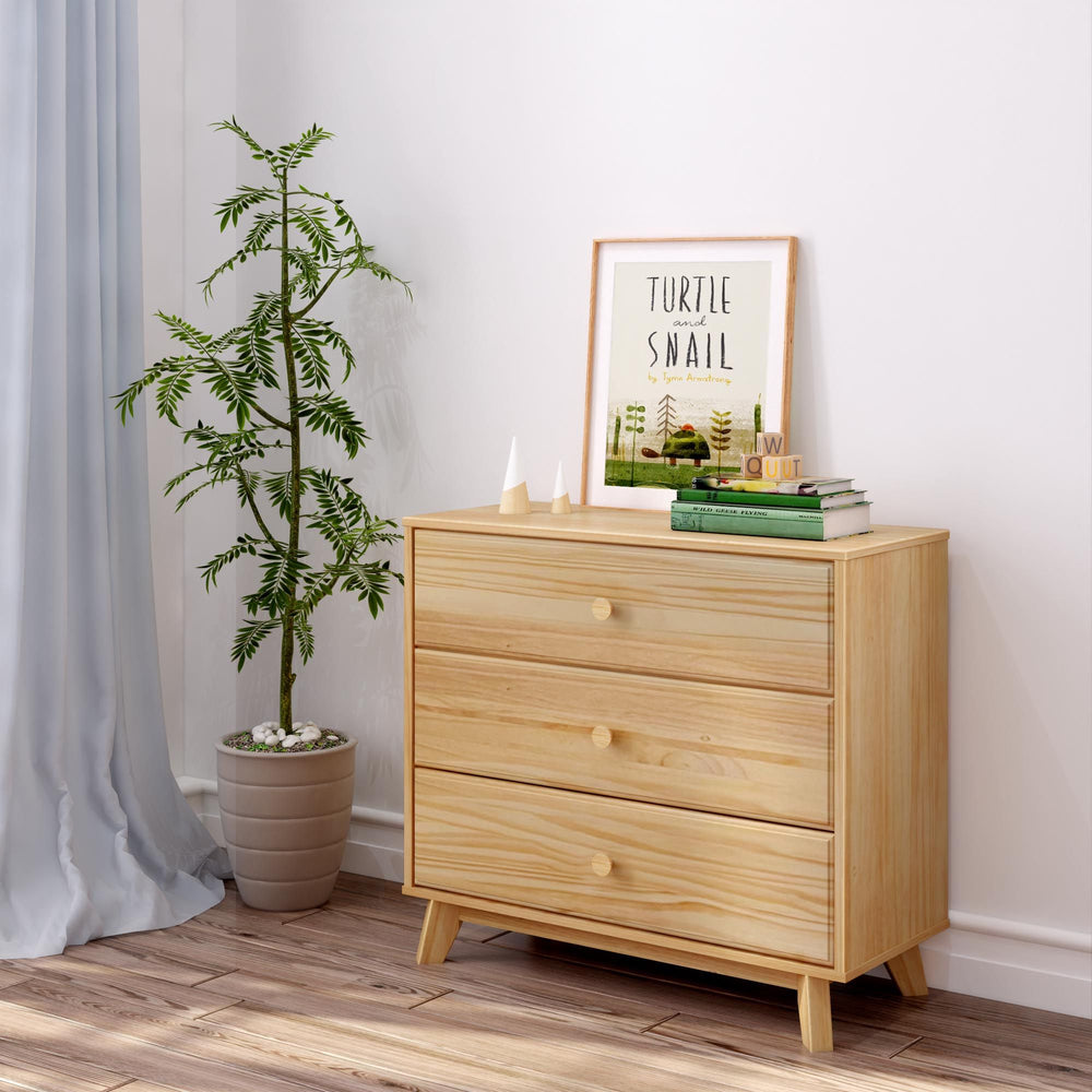 Pine wood dresser with books and plant, modern minimalist bedroom decor.