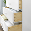 White wooden dresser with open drawers showing folded linens and towels, modern bedroom storage and organization