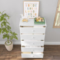 White five-drawer nursery dresser with open drawers on hardwood floor, alphabet print, wooden toy horse and potted plant