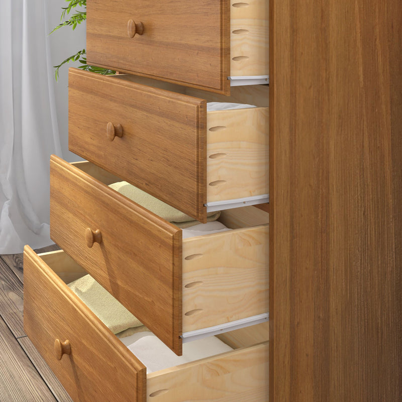 Solid natural wood dresser with several open drawers revealing neatly folded towels and linens, bedroom chest of drawers on hardwood floor