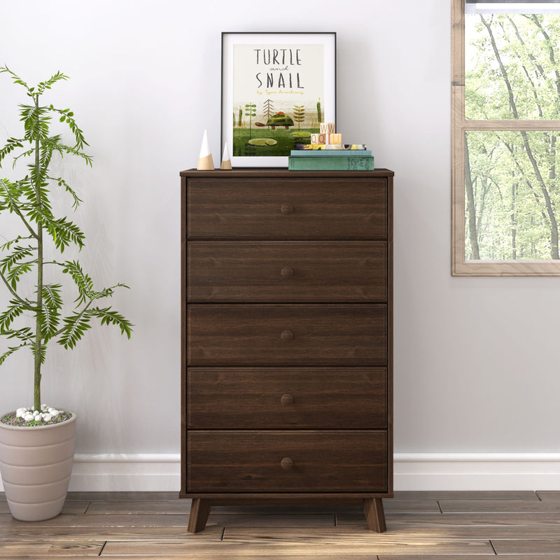 Mid-century modern wooden dresser with decorative items, next to a potted plant in a bright room.
