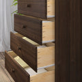 Dark wood dresser with multiple open drawers revealing light-wood interiors and neatly folded towels for bedroom storage