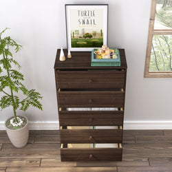 Dark wooden dresser with open drawers and decorative items including a framed "Turtle and Snail" artwork, wooden blocks, and plants, in a well-lit room with hardwood floors and potted plant.