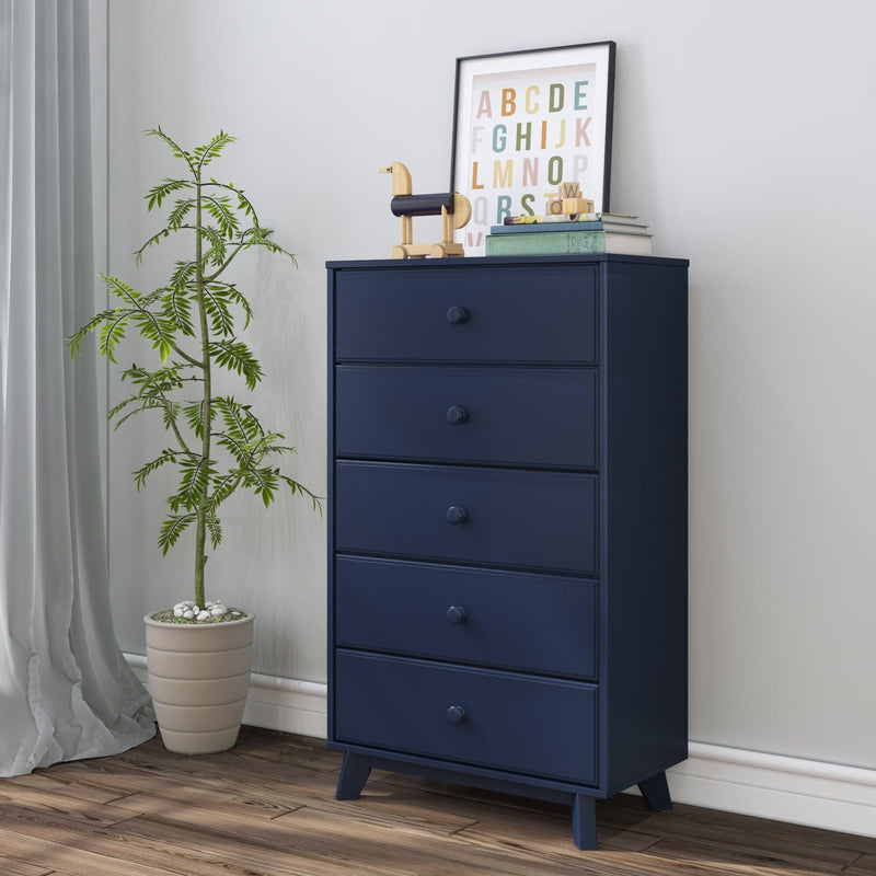 Modern navy blue five-drawer chest of drawers in nursery or bedroom with wooden toy, framed alphabet print, potted plant and hardwood floor