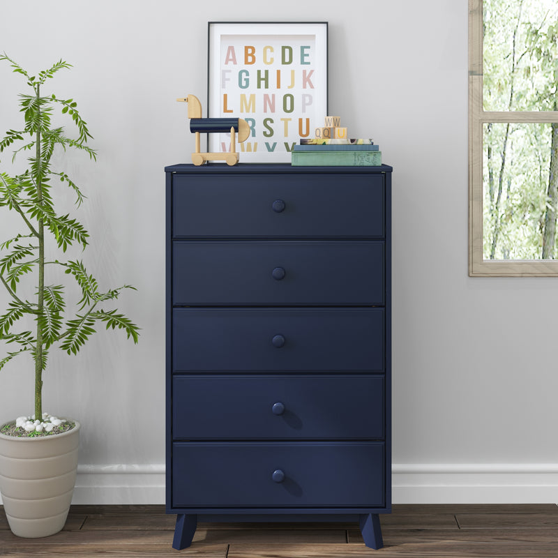 Blue dresser with five drawers and decorative items next to a potted plant in a modern room.