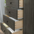 Dark gray wood dresser with open drawers and natural pine interiors holding folded linens, modern bedroom storage chest of drawers
