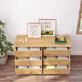 Pine six-drawer dresser in a children’s room with neatly folded clothes in open drawers, framed alphabet and turtle-and-snail prints, potted plant and toys on top