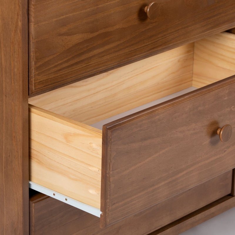 Close-up of brown solid wood dresser with open drawer showing light pine interior, bedroom storage furniture