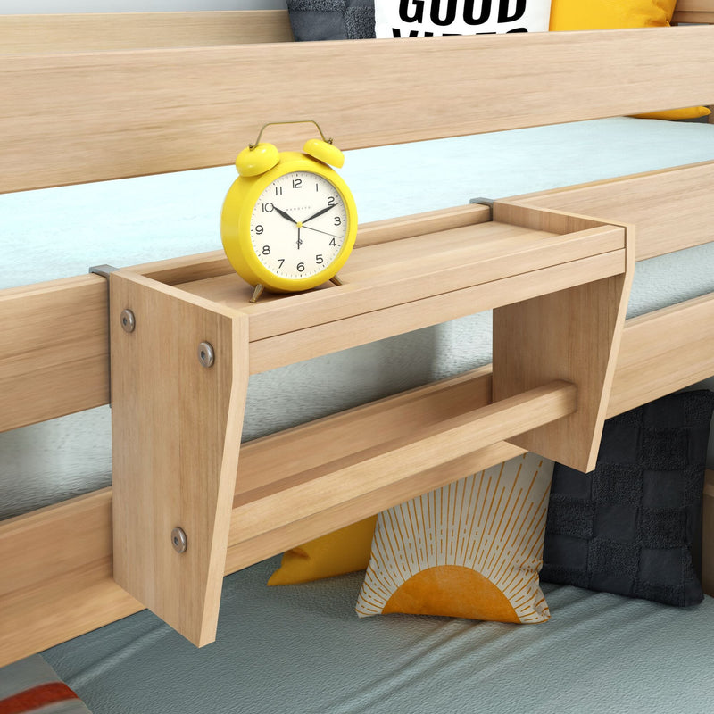 Wooden attached bedside shelf for bunk bed holding a yellow alarm clock and decorative pillows