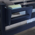 Navy blue bunk bed rail with built-in bedside shelf holding books and a water bottle, children's bedroom storage solution