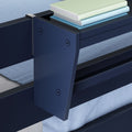 Close-up of navy blue bunk bed frame and railing with built-in shelf holding pastel books and light-blue bedding, modern kids' loft bed