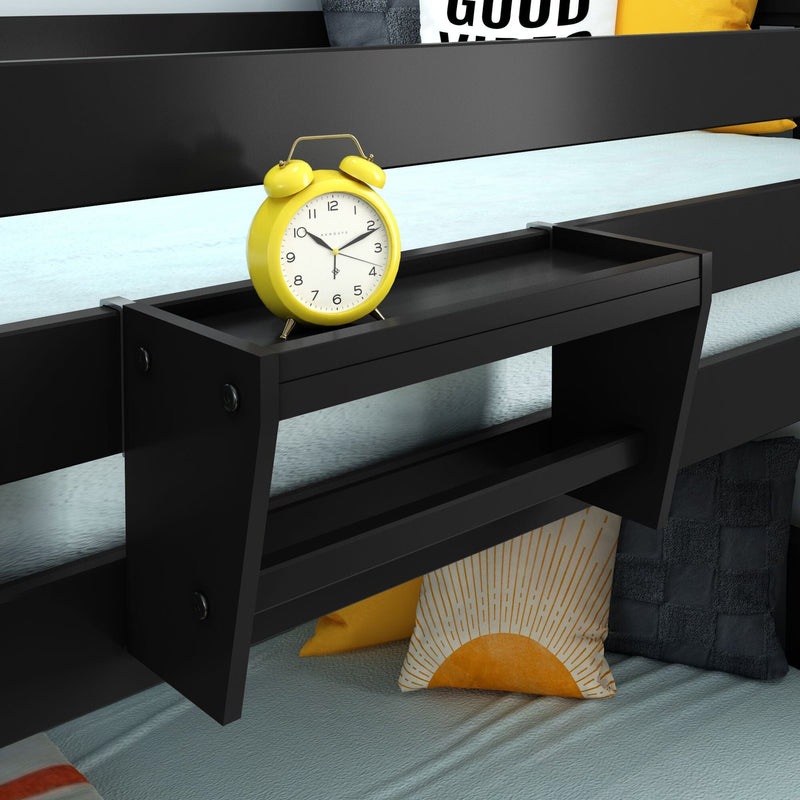 Black bedside storage shelf attached to bunk bed with yellow retro alarm clock and sun-print throw pillows on light blue bedding, modern kids bedroom