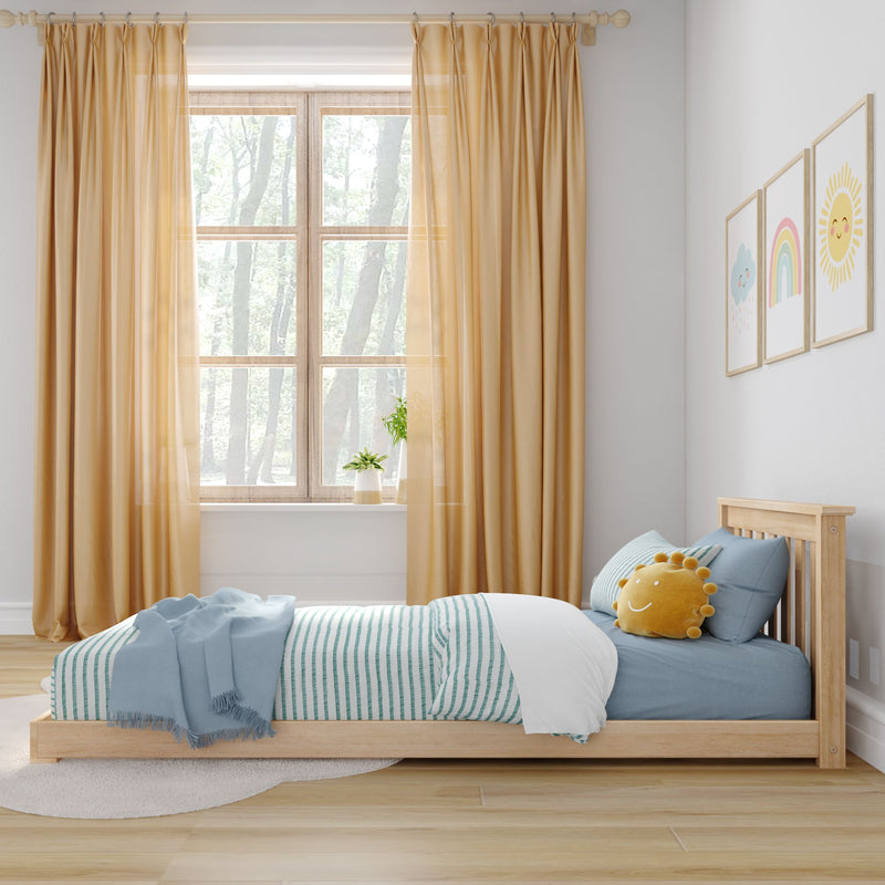 Cozy kids' bedroom with sunlight coming through a window, featuring a wooden bed, blue striped bedding, and cheerful wall art.