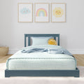 Blue kids bed with striped bedding and sun plush under three pastel nursery prints (cloud, rainbow, sun)