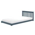 Blue wooden platform bed with slatted headboard and white mattress, modern low-profile frame for bedroom or kids' room