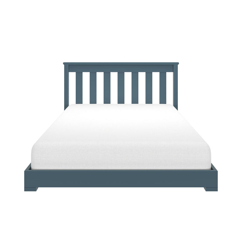 Blue wooden slatted twin bed frame with white mattress on a minimalist platform — modern single bed headboard close-up