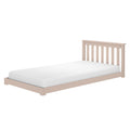 Beige wooden twin bed frame with slatted headboard and white mattress on a minimalist platform, isolated on a white background