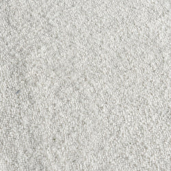 Close-up of white carpet texture with soft looped fibers — plush rug flooring background for home interior design