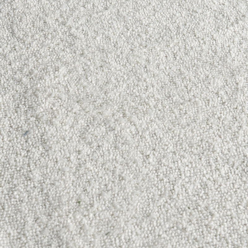 Close-up of white carpet texture with soft looped fibers — plush rug flooring background for home interior design