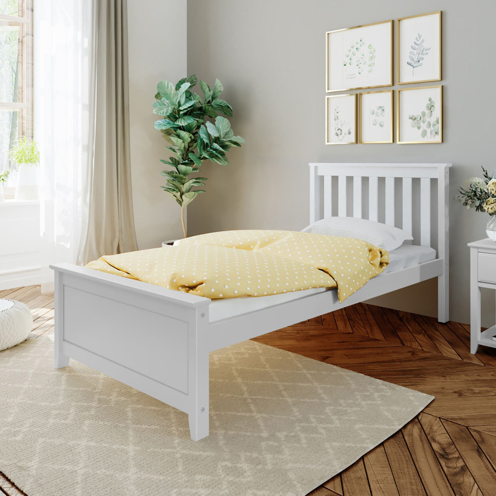 Simple and elegant white wooden bed frame in a cozy bedroom with a yellow polka dot comforter, indoor plant, and decorative wall art.