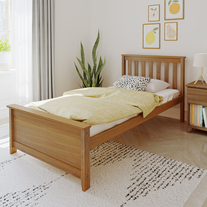 Stylish wooden bed frame in modern bedroom with cozy yellow blanket and decorative pillows.
