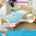 Solid pine toddler bed with removable guardrail and blue polka-dot bedding in nursery, showing easy-install guardrail and metal support bracket for safety
